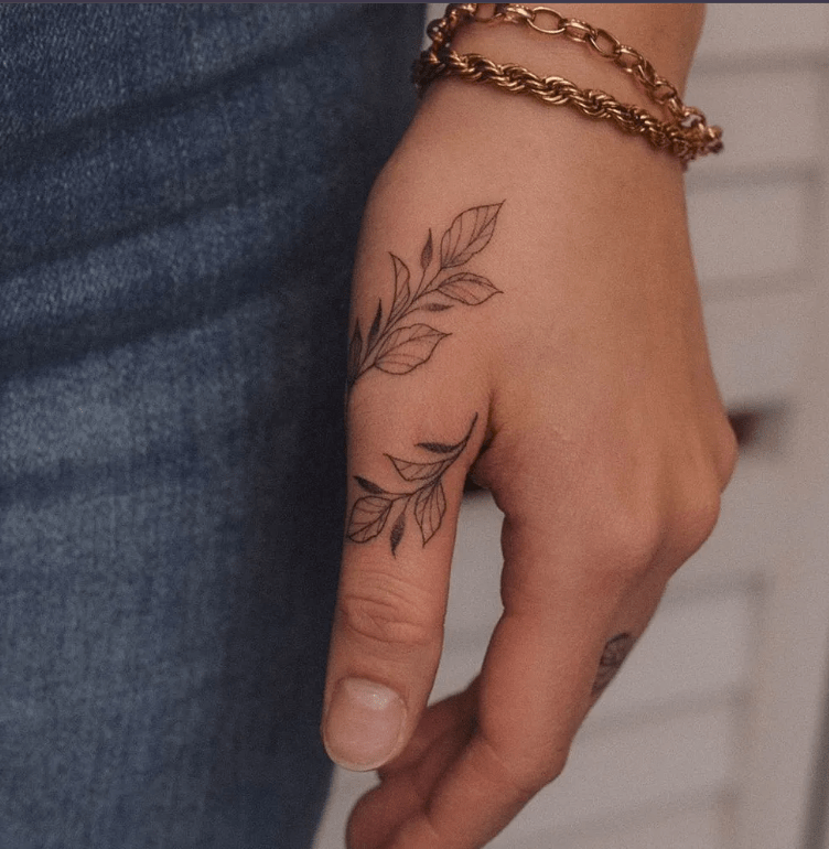 flower tattoo on thumb and hand for female, finger tattoo ideas for females